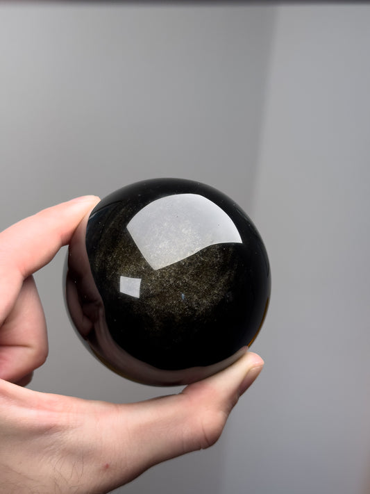 Gold sheen obsidian sphere