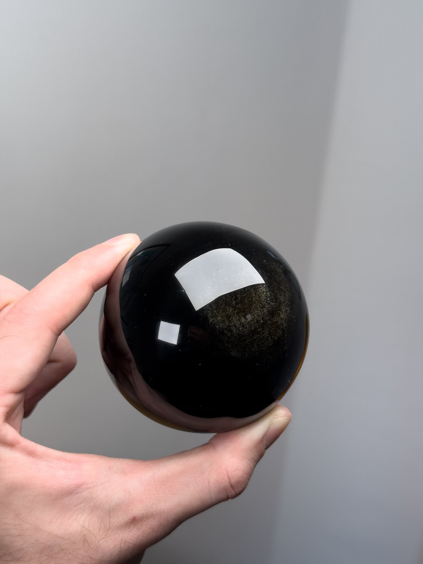 Gold sheen obsidian sphere