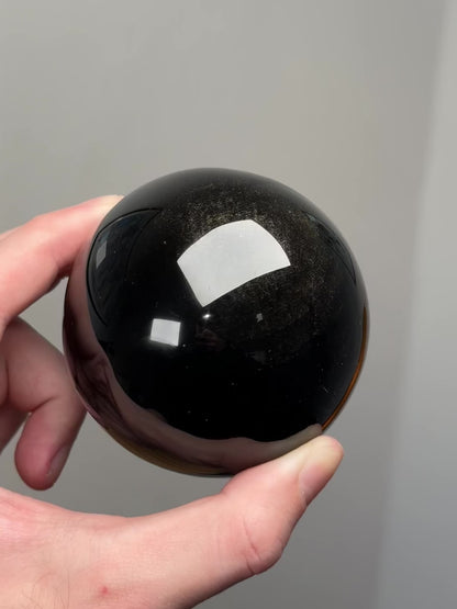 Gold sheen obsidian sphere